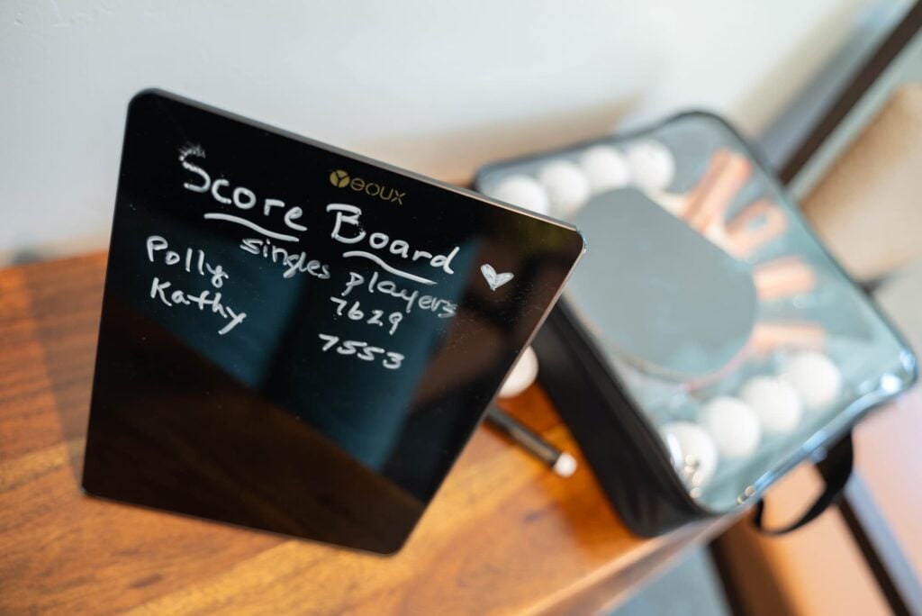 La Posada Pusch Ridge scoreboard between two players Polly and Kathy, written with a wet white marker on a small clip black board
