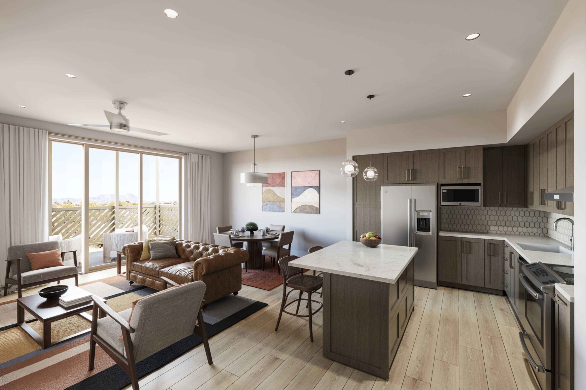 Celosia apartment interior showing an open-concept kitchen, dining area and living room with light wood flooring. The kitchen features dark wood cabinetry, stainless steel appliances, stone countertops and a large island, while the living area includes a leather sofa, accent chairs and access to a balcony with mountain views.