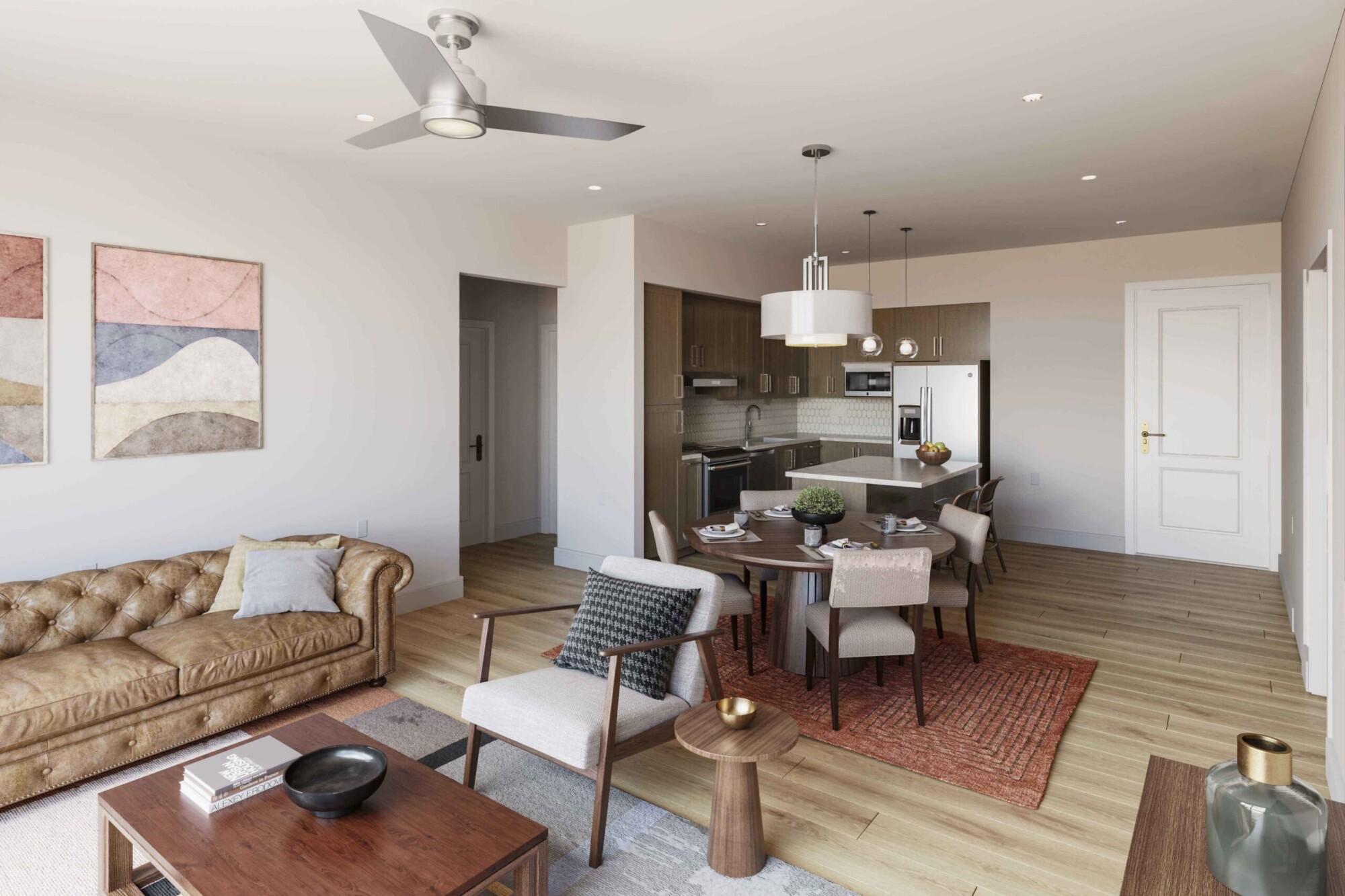Marigold apartment interior with an open living room, dining area and kitchen. The space features a leather sofa, accent chair, dining table for four, wood-look flooring and a kitchen with dark cabinetry, stainless steel appliances and a center island with bar seating.